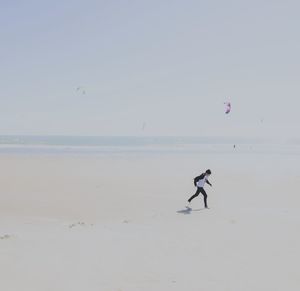 Full length of boy running at beach