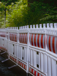 Row of red railing by fence