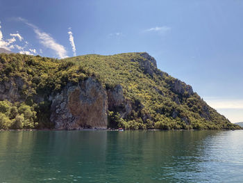 Ohrid lake on background mountains with forest and blue sky