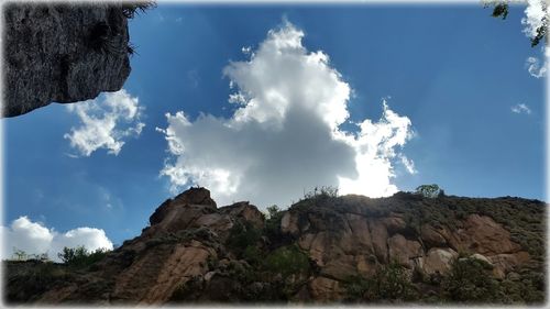 Low angle view of rock formation against sky