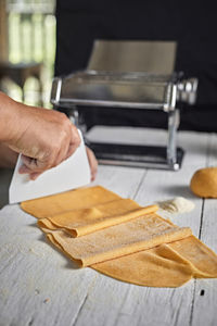 Cropped hand of woman holding paper