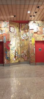 Graffiti on tiled floor in illuminated warehouse