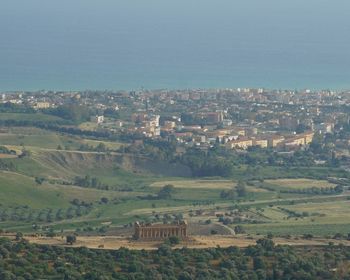 High angle view of agricultural field against buildings in city