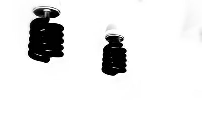 Low angle view of electric lamp against white background