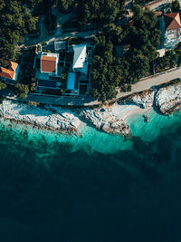 Swimming pool by sea against buildings