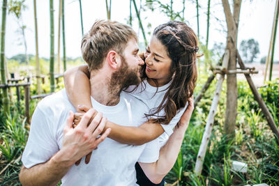 Smiling couple embracing on field