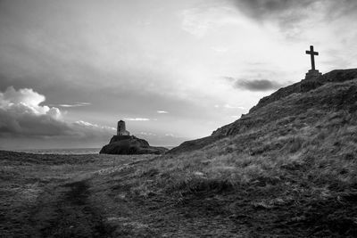 Low angle view of lighthouse amidst buildings against sky