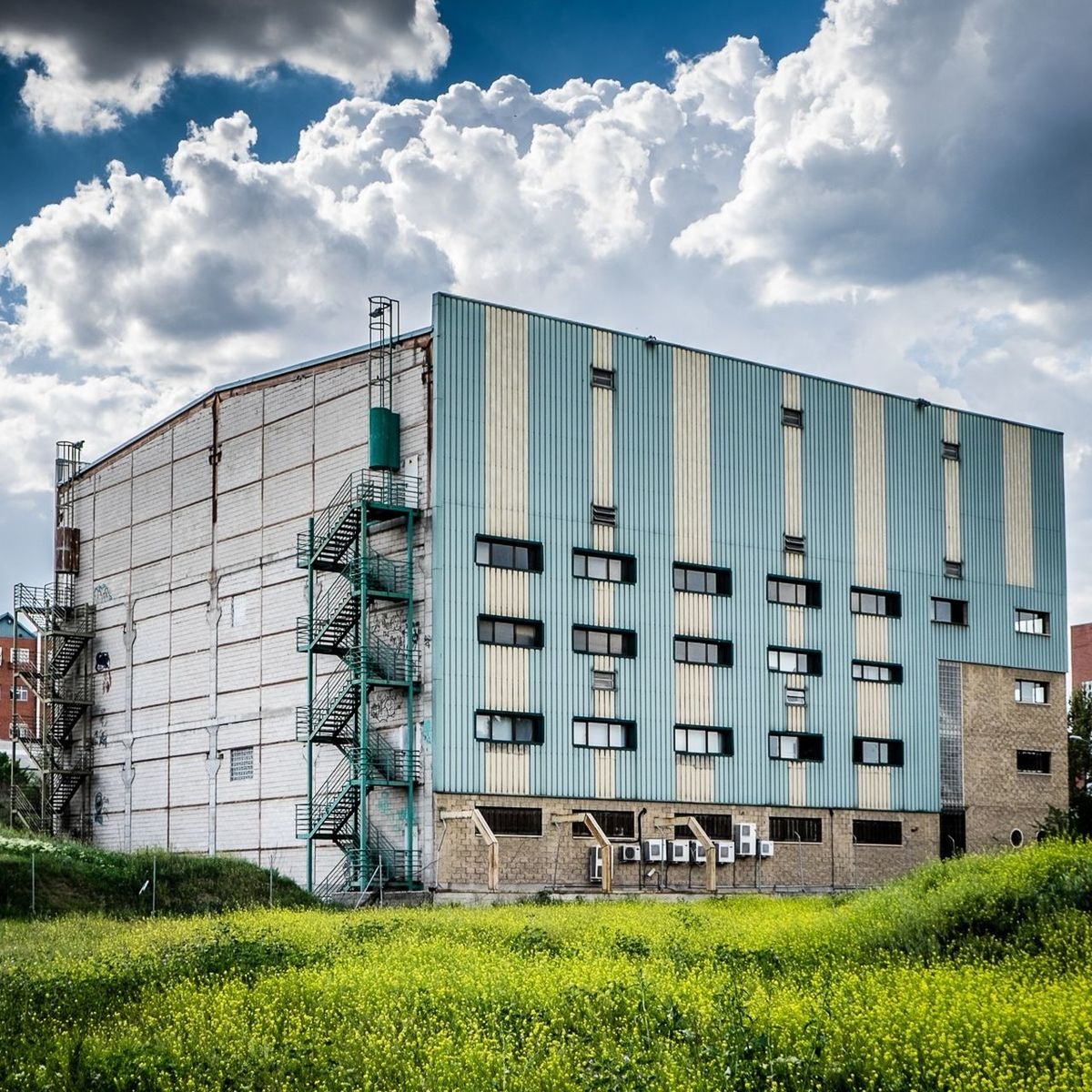 Factory against cloudy sky