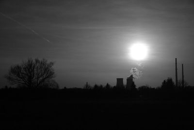 Silhouette of bare trees against sky