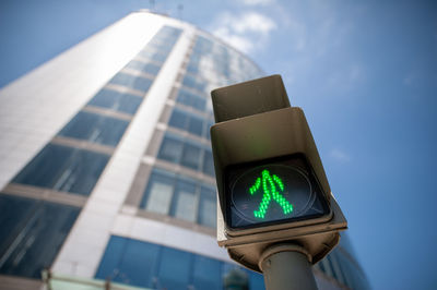 Low angle view of road sign against sky