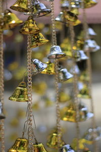 Close-up of small bells hanging outdoors