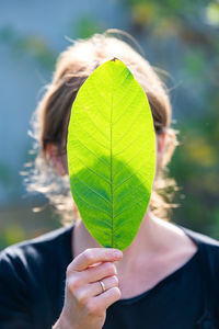 Close-up of woman holding leaves