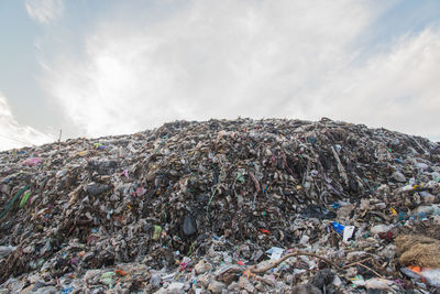 Stack of garbage against sky