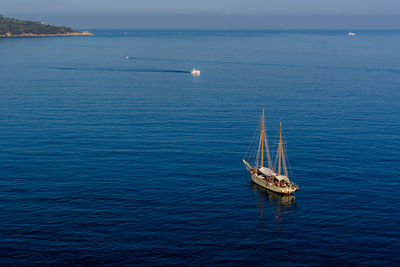 High angle view of sailboat on blue sea