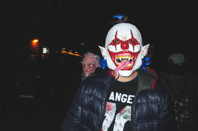 Man wearing halloween costume on street at night