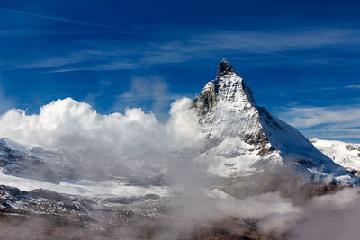 Aerial view of snowcapped mountain against sky