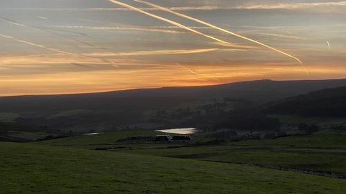 Scenic view of landscape against sky during sunset