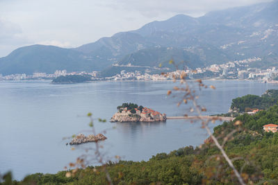 Scenic view of sea and mountains against sky