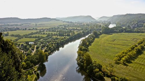 Panoramic view of agricultural field against sky