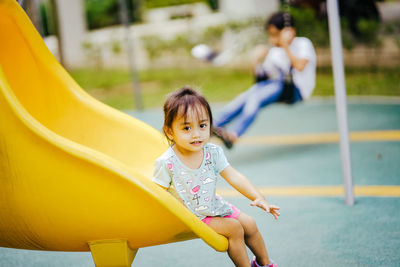 Low angle view of cute girl playing at playground
