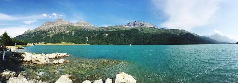 Panoramic view of sea and mountains against sky