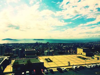 High angle view of city against cloudy sky