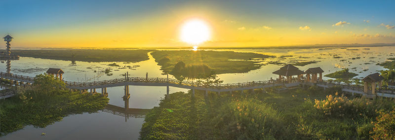 Bridge over river during sunset