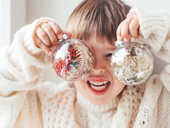 Close-up of woman holding christmas decoration