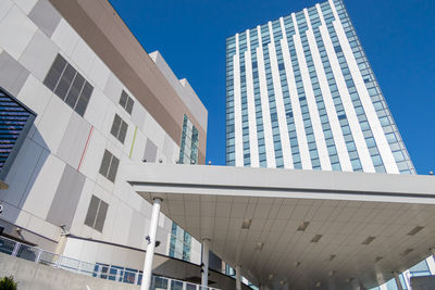 Low angle view of modern buildings against clear blue sky