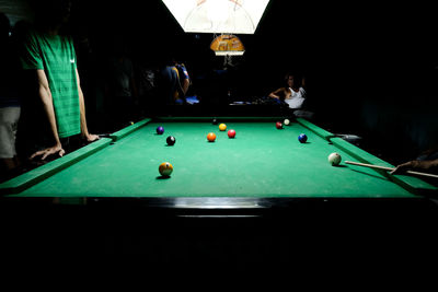 People playing with ball on table