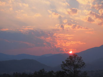 Scenic view of silhouette mountains against sky during sunset