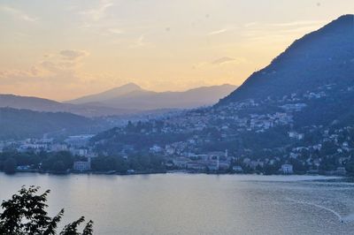 Scenic view of lake by mountains against sky