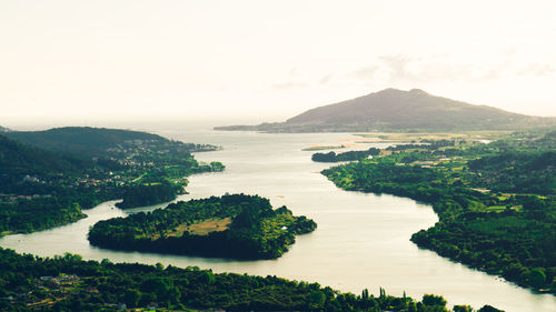 Scenic view of sea, river and mountains against clear sky