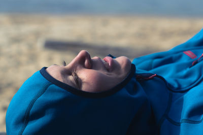 Close-up of woman lying on beach