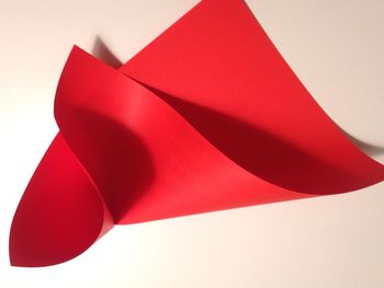 High angle view of red craft paper on white background