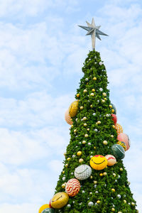 Low angle view of christmas tree against sky
