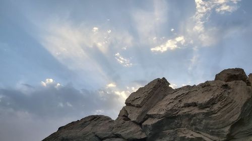 Low angle view of rock formation against sky