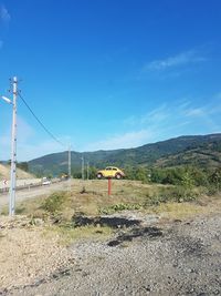 Scenic view of field against blue sky