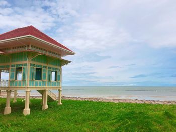 Built structure on beach against sky