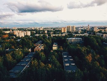 High angle view of cityscape against cloudy sky