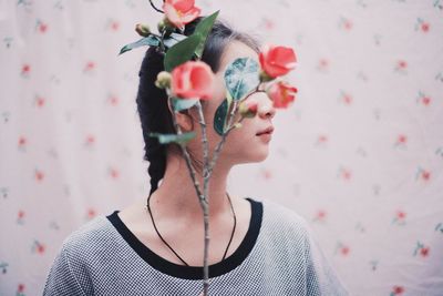 Close-up of flowers against young woman