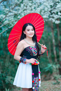 Portrait of a smiling girl holding umbrella