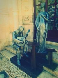 Statue of man sitting on seat