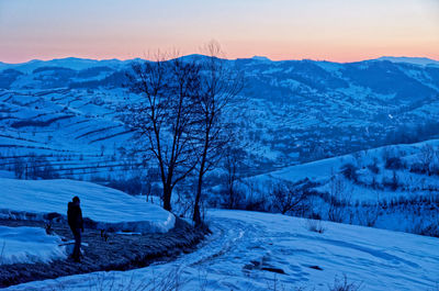 Scenic view of snow covered mountains against sky