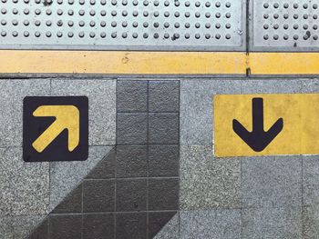 Close-up of yellow sign on wall