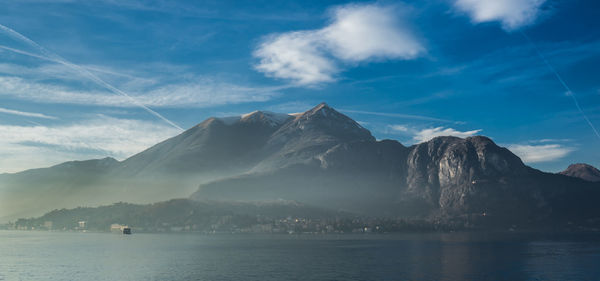 Scenic view of sea and mountains against sky