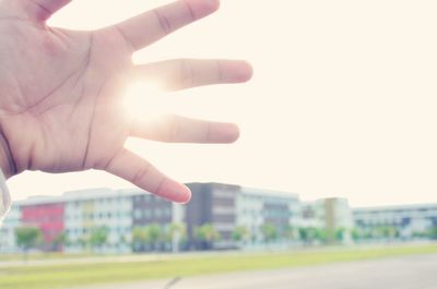 Close-up of person hand against clear sky