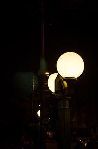 Low angle view of lamp post at night