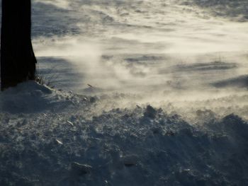 Close-up of snow on beach against sky