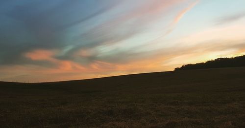 Scenic view of silhouette land against sky during sunset